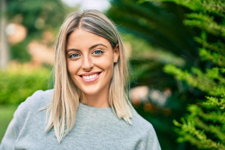 a photo of a woman with healthy confident smile