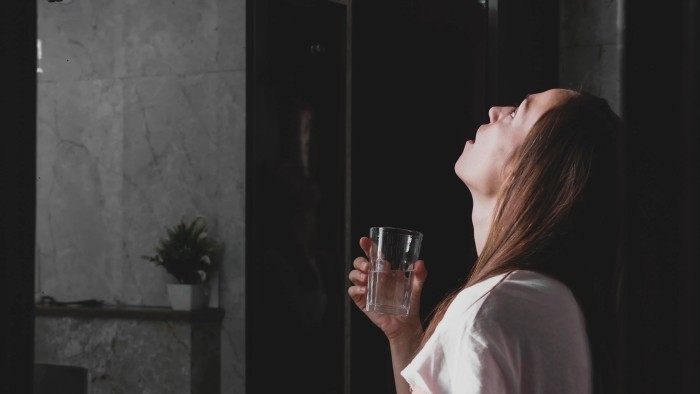 A woman gargling salt water to help improve tonsil stones